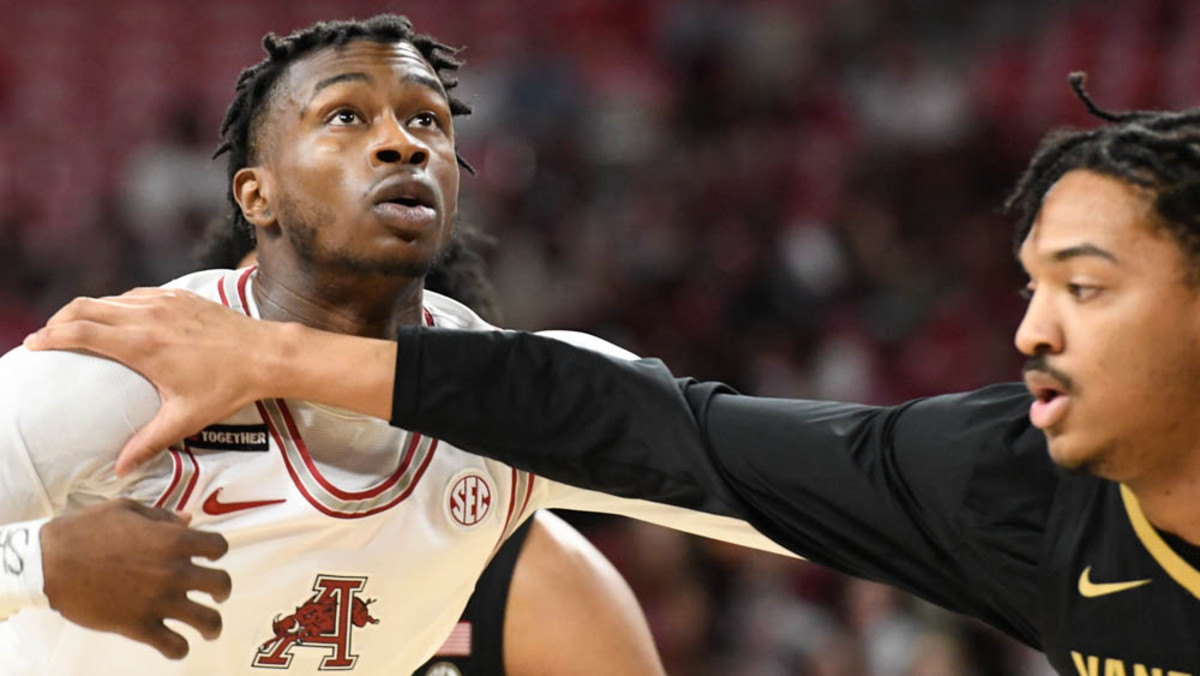 Razorbacks' Devo Davis being held by Vanderbilt's Evan Taylor